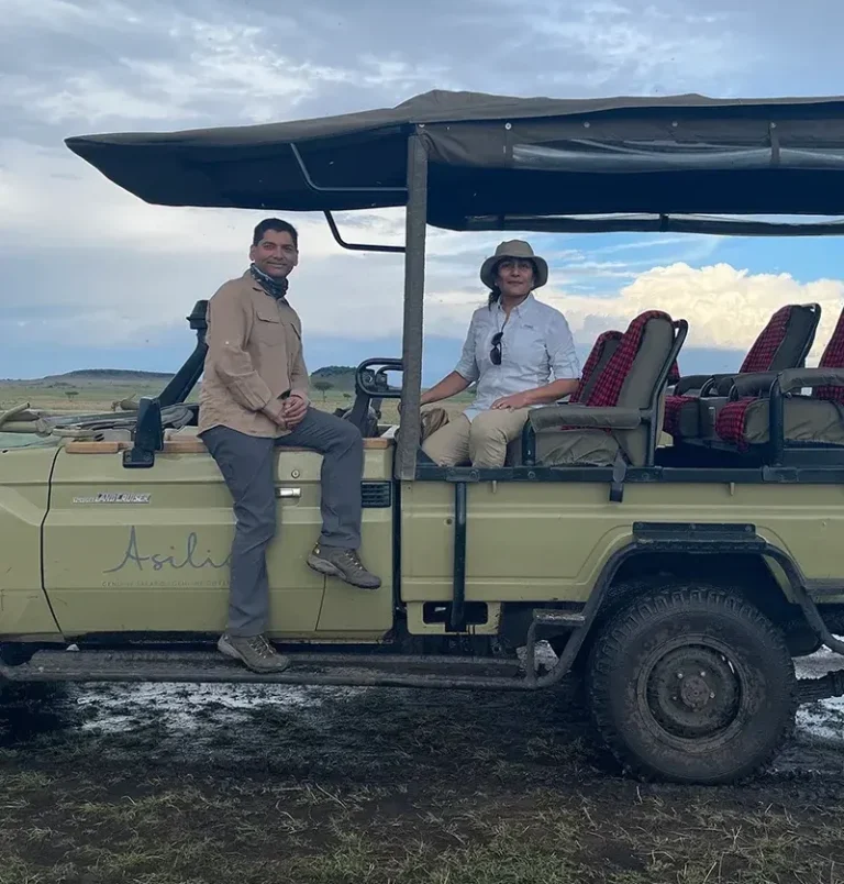 pranav & anita setting on game drive in africa